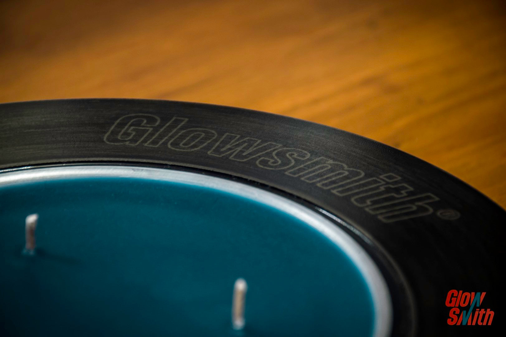 Close-up of painted brake disc with burning Nordic Pine candle insert