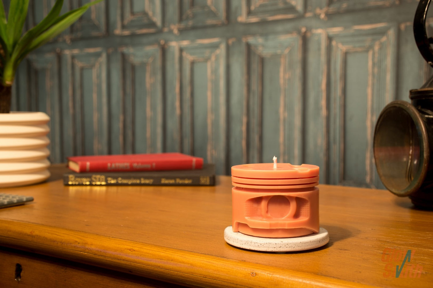Spiced Orange engine piston candle styled in man cave or automotive-inspired room