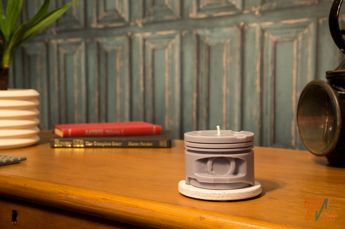 Close-up of the Dark Opium Engine Piston Candle showing fine piston detailing and a sleek grey wax finish inspired by high-performance sports car engines.