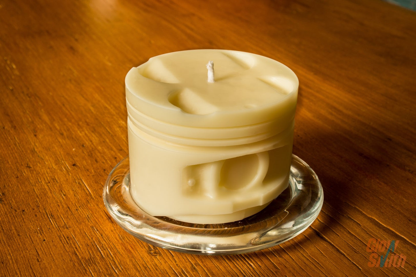 Close-up of the ivory piston design and wax finish of the Smoked Vanilla Engine Piston Candle.