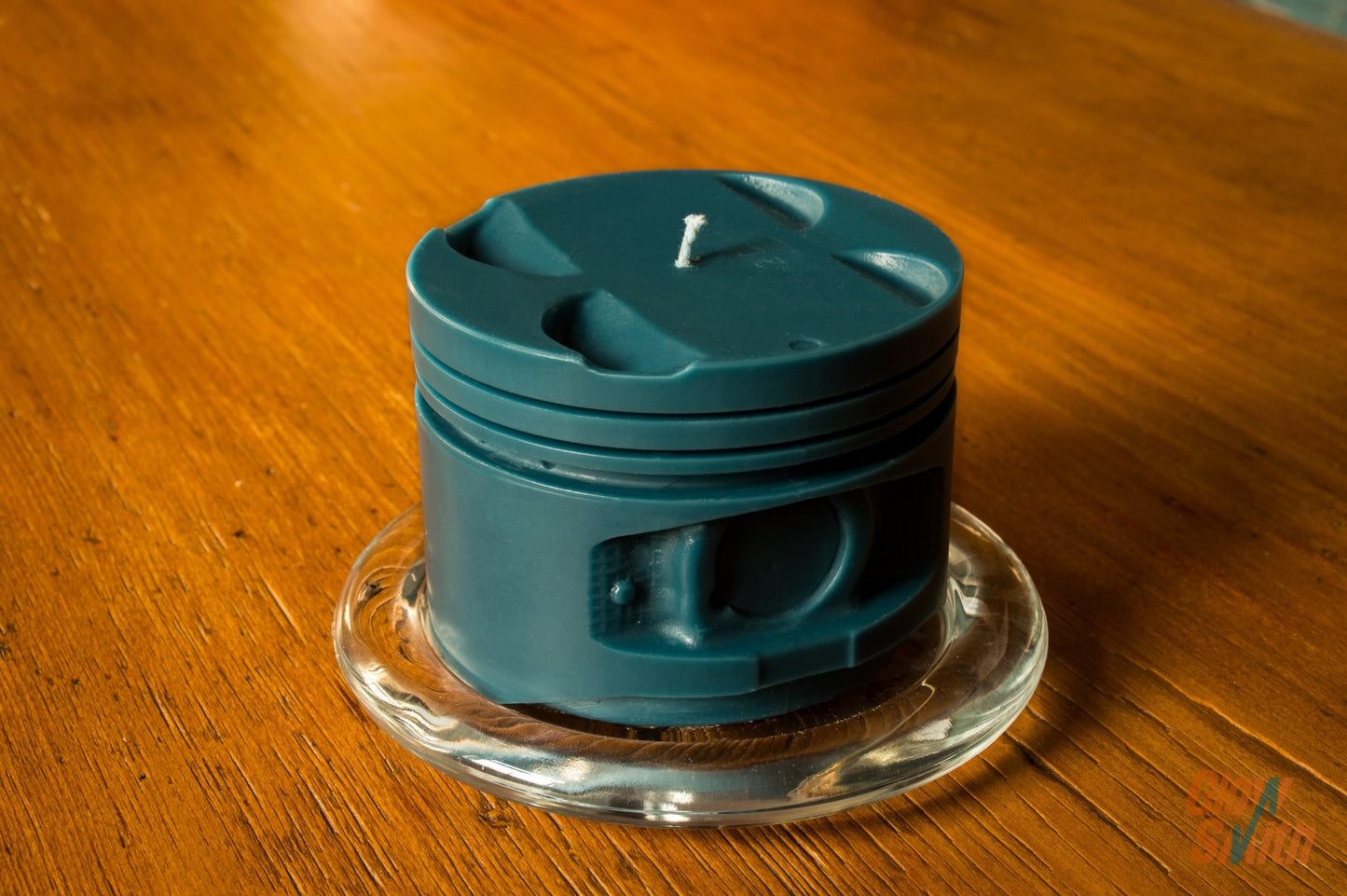 Close-up showing the detailed piston grooves and blue wax finish of the Nordic Pine Engine Piston Candle.