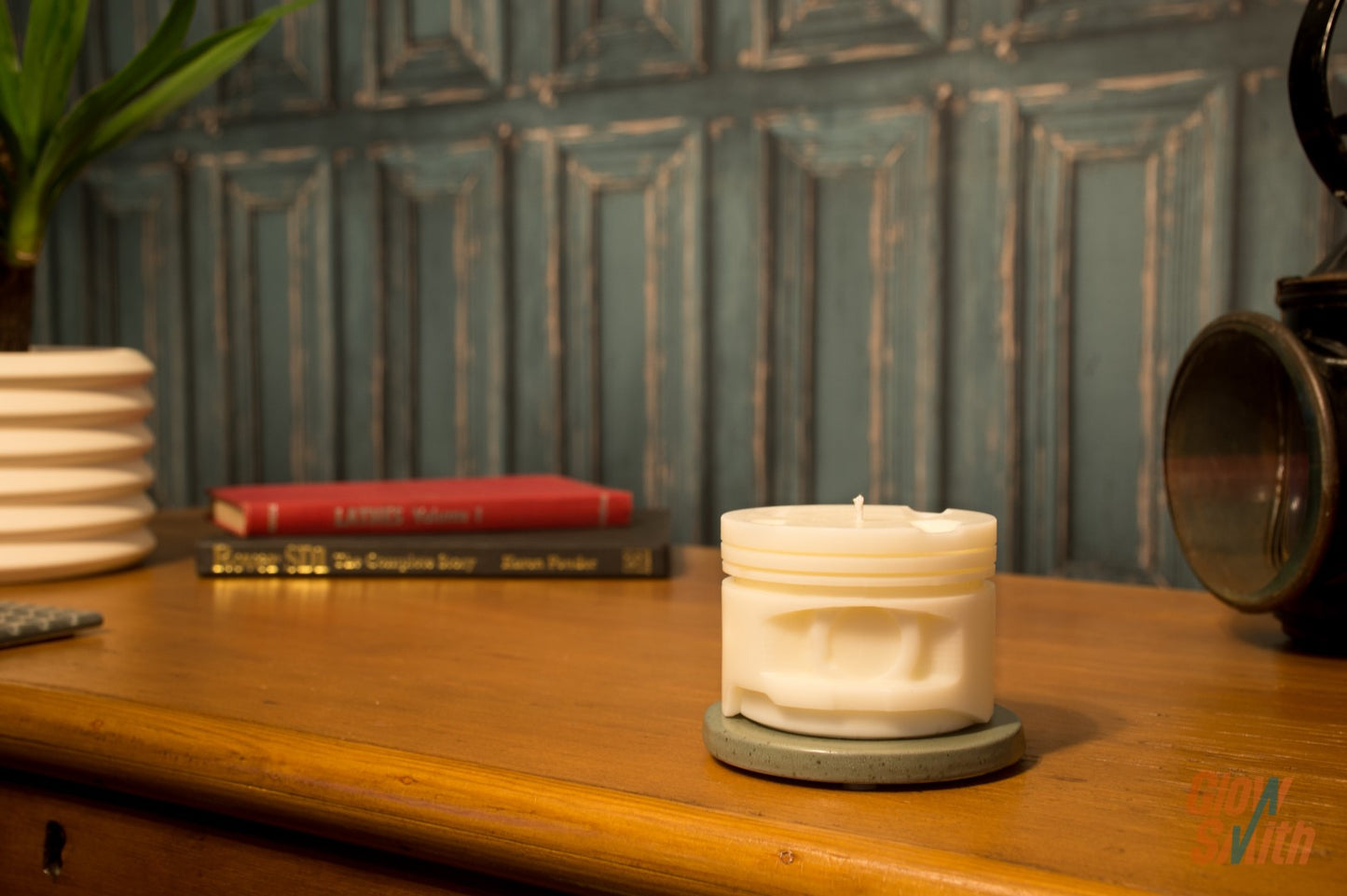 Close-up of the White Fresh Linen Engine Piston Candle showing detailed piston grooves and white wax finish.