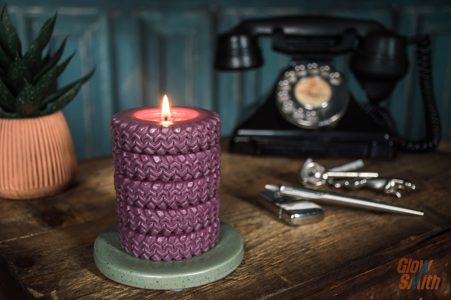 Wild Pomegranate Tyre Stack candle burning in a lounge – maroon sculptural candle, automotive-inspired décor, masculine relaxing fragrance
