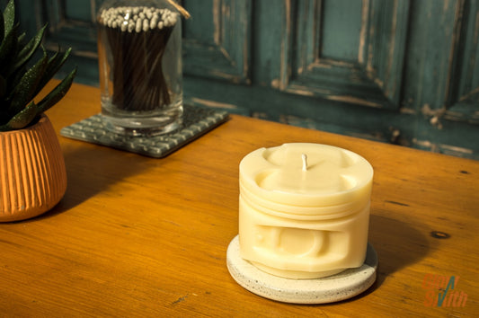 Ivory Smoked Vanilla Engine Piston Candle photographed from the left side in a man cave, highlighting its piston design and calming effect.