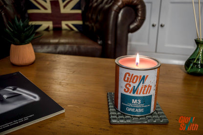 Lit Spiced Orange Large Grease Tin Candle, adding a warm, industrial feel to a man's space.