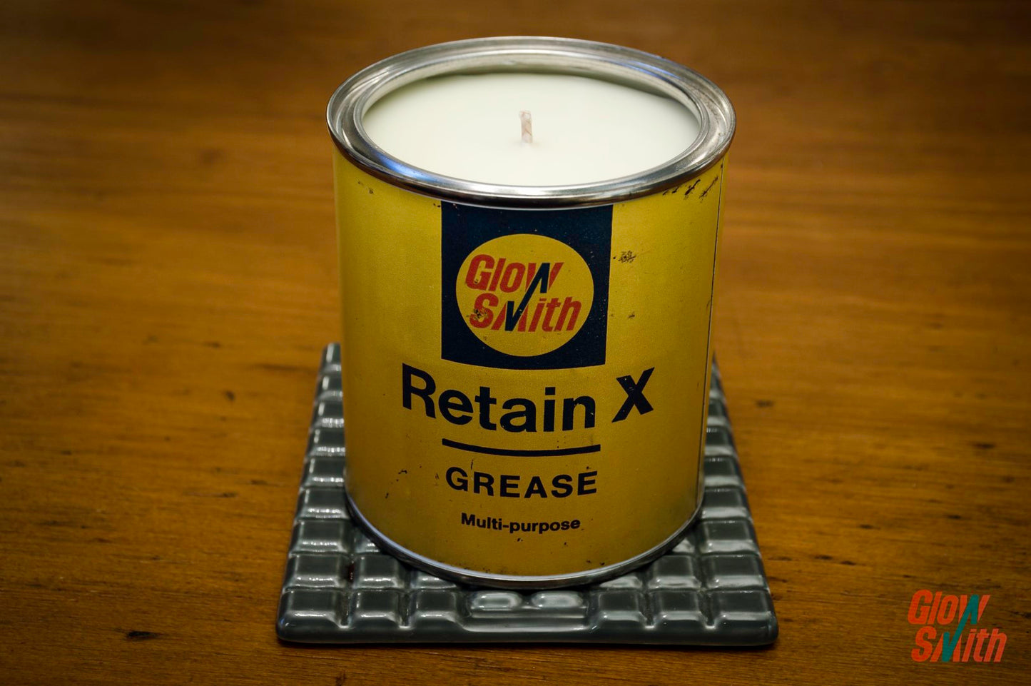 Smoked Vanilla Grease Tin Candle styled in a modern home office