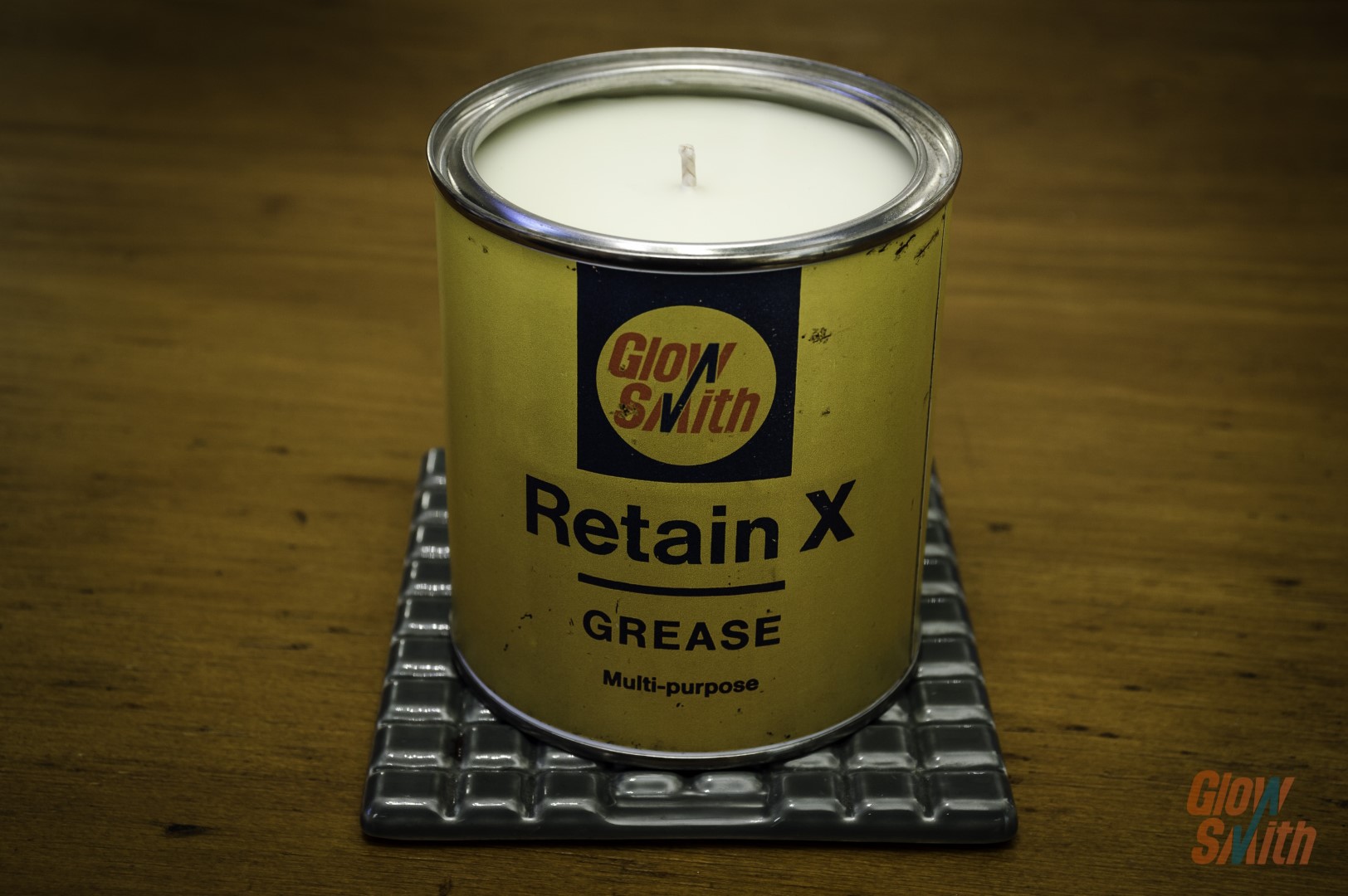 Smoked Vanilla Grease Tin Candle styled in a modern home office