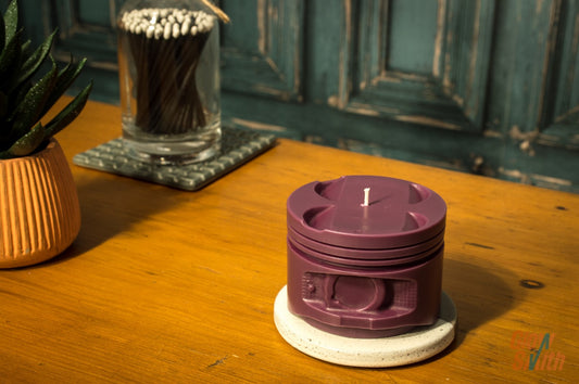 Wild Pomegranate engine piston candle shown from side on dark background